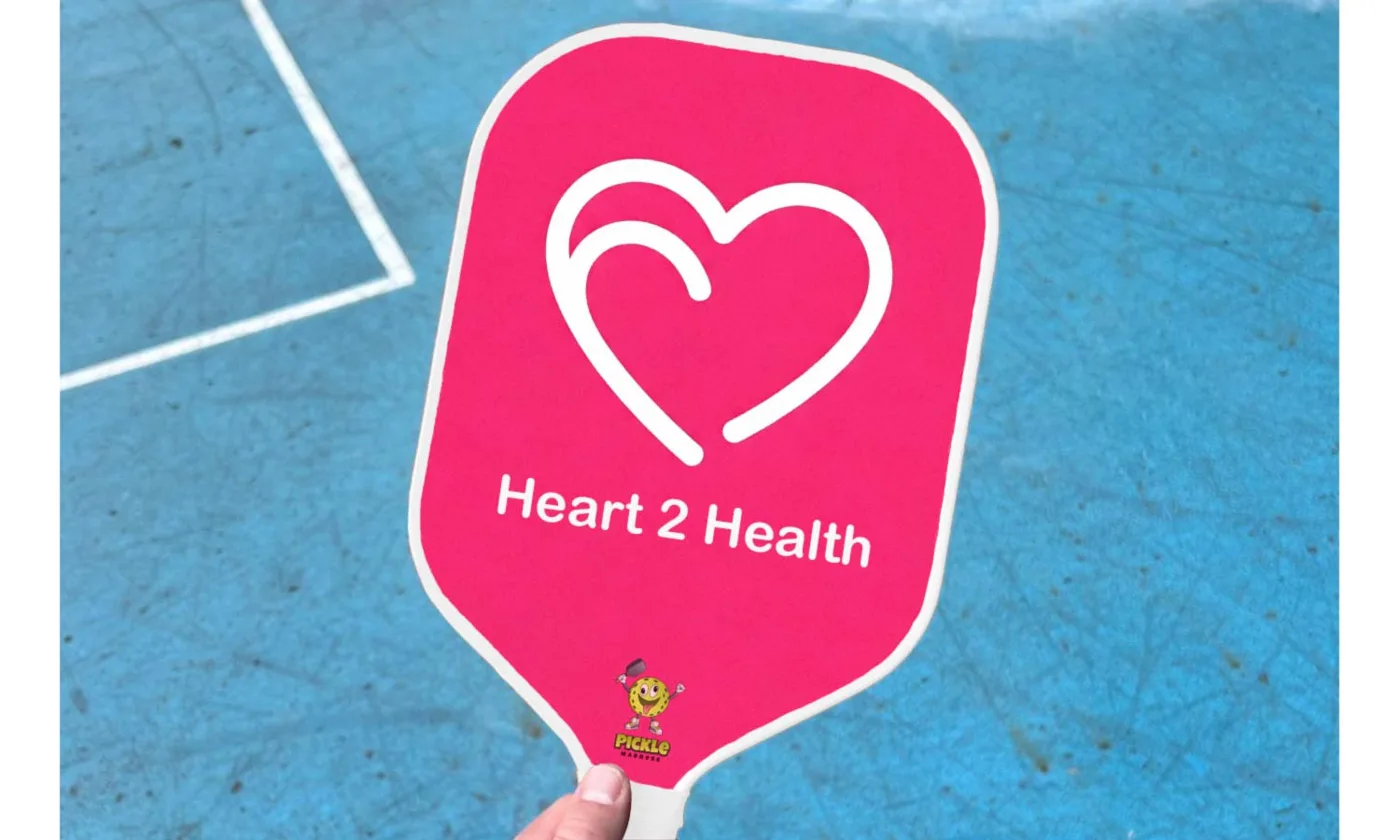 A personalized pink paddle with a heart logo